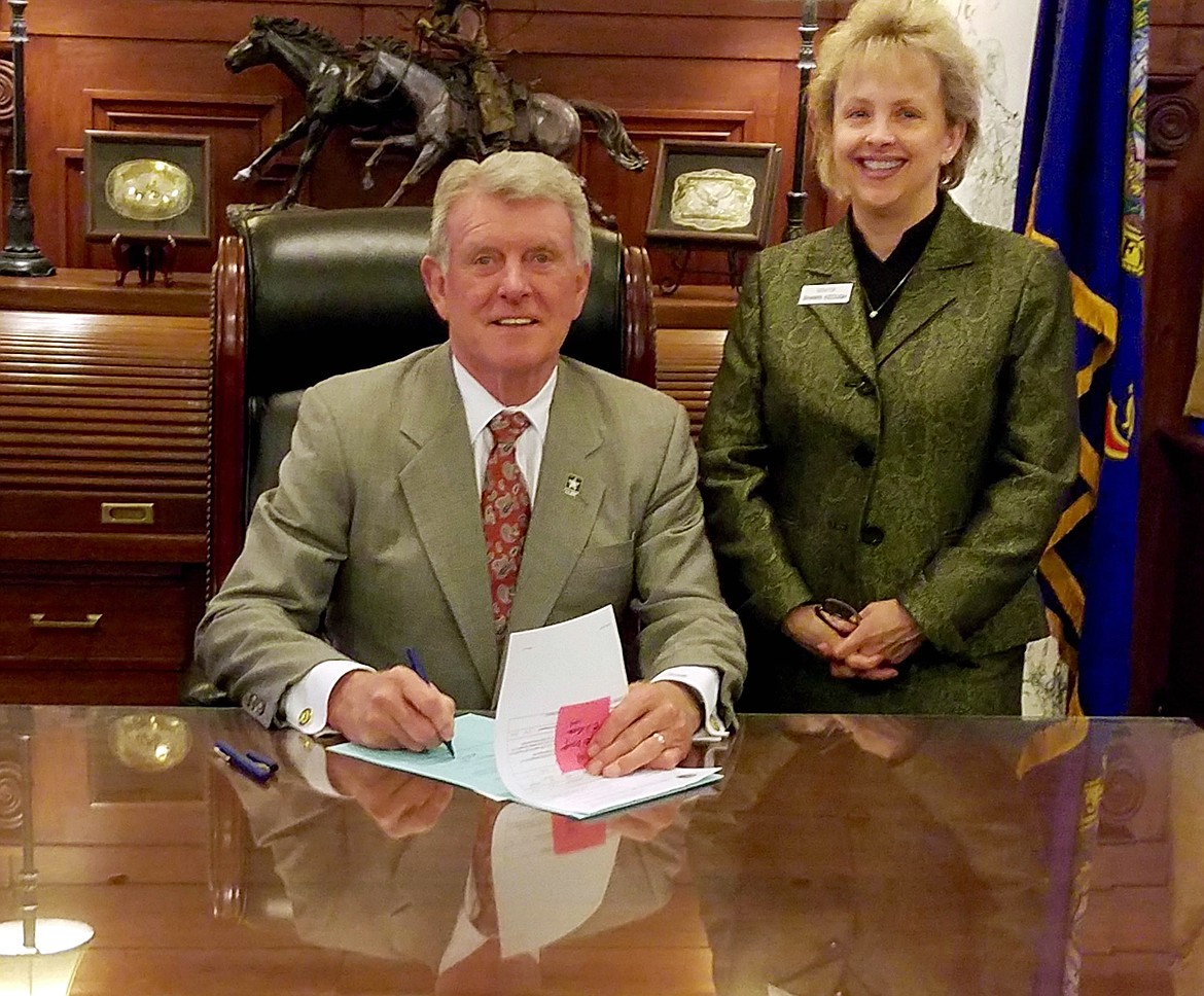 (Courtesy photo)
Idaho Sen. Shawn Keough stands by as Gov. Butch Otter signs one of her final legislative victories into law &#151; funding for projects at Priest Lake.