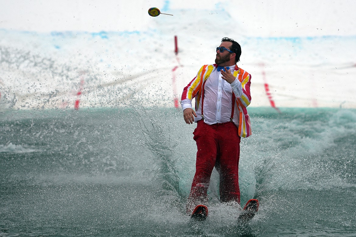 Billy &#147;The Candy Man&#148; Marcial tosses a lollypop into the crowd as he successfully crosses the pond during the 2018 Whitefish Pond Skim at Whitefish Mountain Resort on Saturday. (Casey Kreider/Daily Inter Lake)