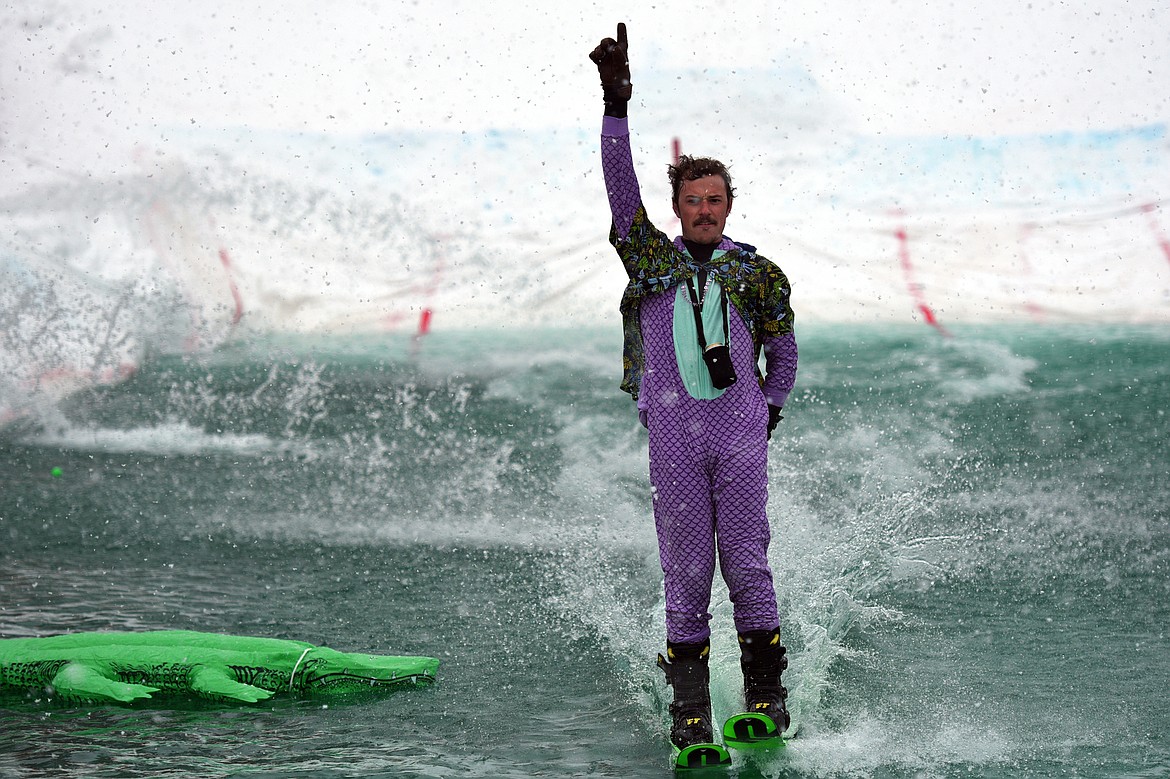 Pond skim ski winner Danner Pickering celebrates a successful run across the pond during the 2018 Whitefish Pond Skim at Whitefish Mountain Resort on Saturday. 
(Casey Kreider/Daily Inter Lake)