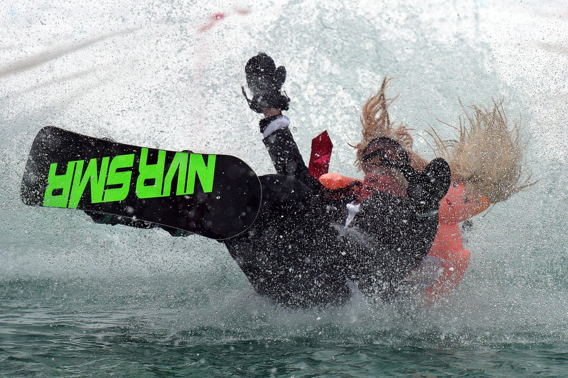 Johnathan Cook, dressed as President Donald Trump and Stormy Daniels, crashes into the pond during the 2018 Whitefish Pond Skim at Whitefish Mountain Resort on Saturday. (Casey Kreider/Daily Inter Lake)