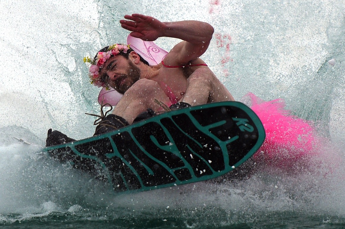 Tim Butler crashes into the pond during the 2018 Whitefish Pond Skim at Whitefish Mountain Resort on Saturday. (Casey Kreider/Daily Inter Lake)