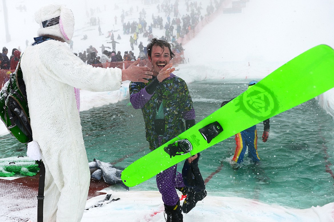 Danner Pickering celebrates after being named the pond skim ski winner at the 2018 Whitefish Pond Skim at Whitefish Mountain Resort on Saturday. (Casey Kreider/Daily Inter Lake)