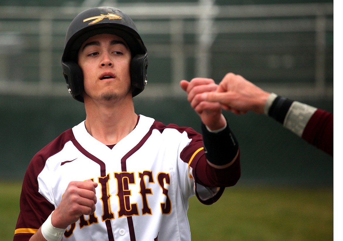 Rodney Harwood/Columbia Basin Herald
Zack Valdez gets a little fist-bump after scoring the first run in Tuesday's 5-1 victory over Eastmont at Larson Playfield.