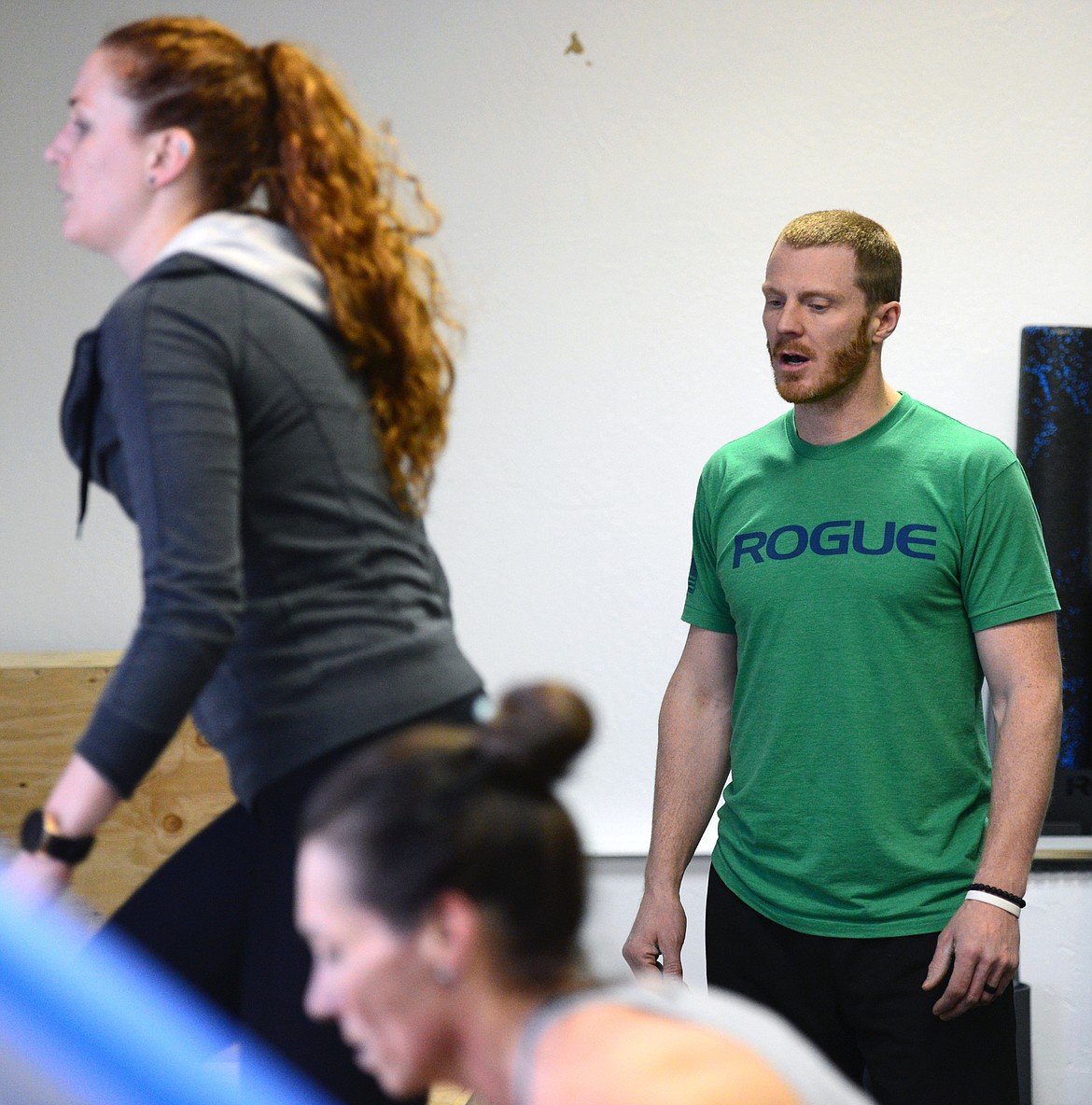 Bigfork Crossfit owner Isaac Lee watches a workout with members Nikkie Armstrong, left, and Shelli Novacek on Wednesday, March 28. (Casey Kreider/Daily Inter Lake)