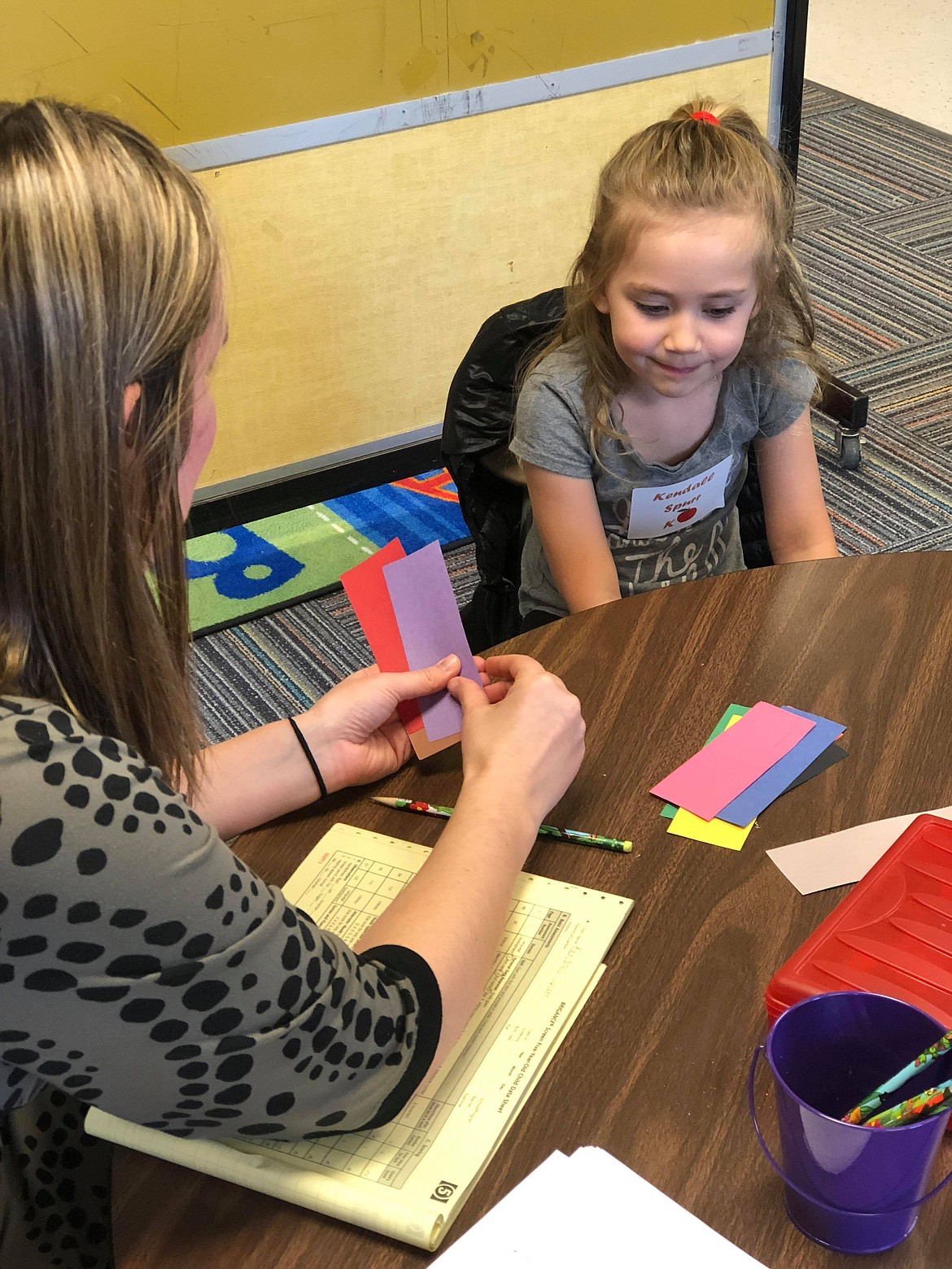 Kendall shows off her skills at identifying color for teacher Jessica Nagy.