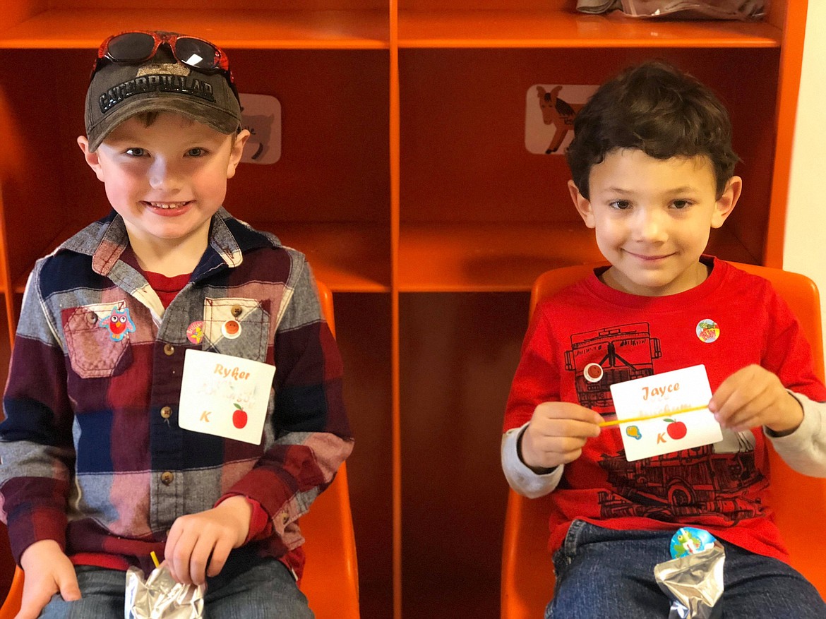 Ryker and Jayce enjoy a cookie and cold juice box. (Erin Jusseaume photos/Clark Fork Valley Press)