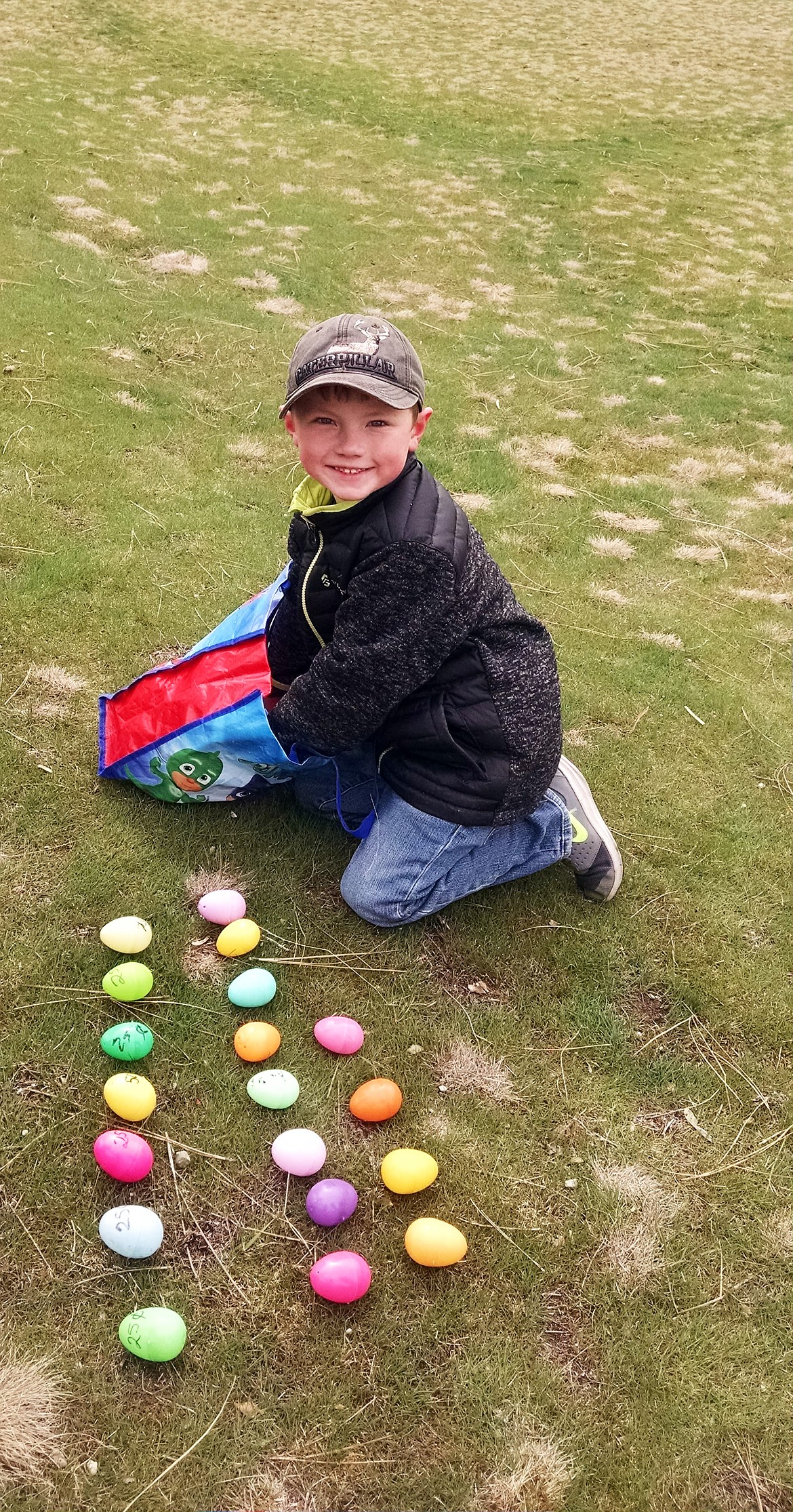 Ryker Anderson counts his eggs after a succesful hunt at the old Paradise School on Sunday. (photo supplied)