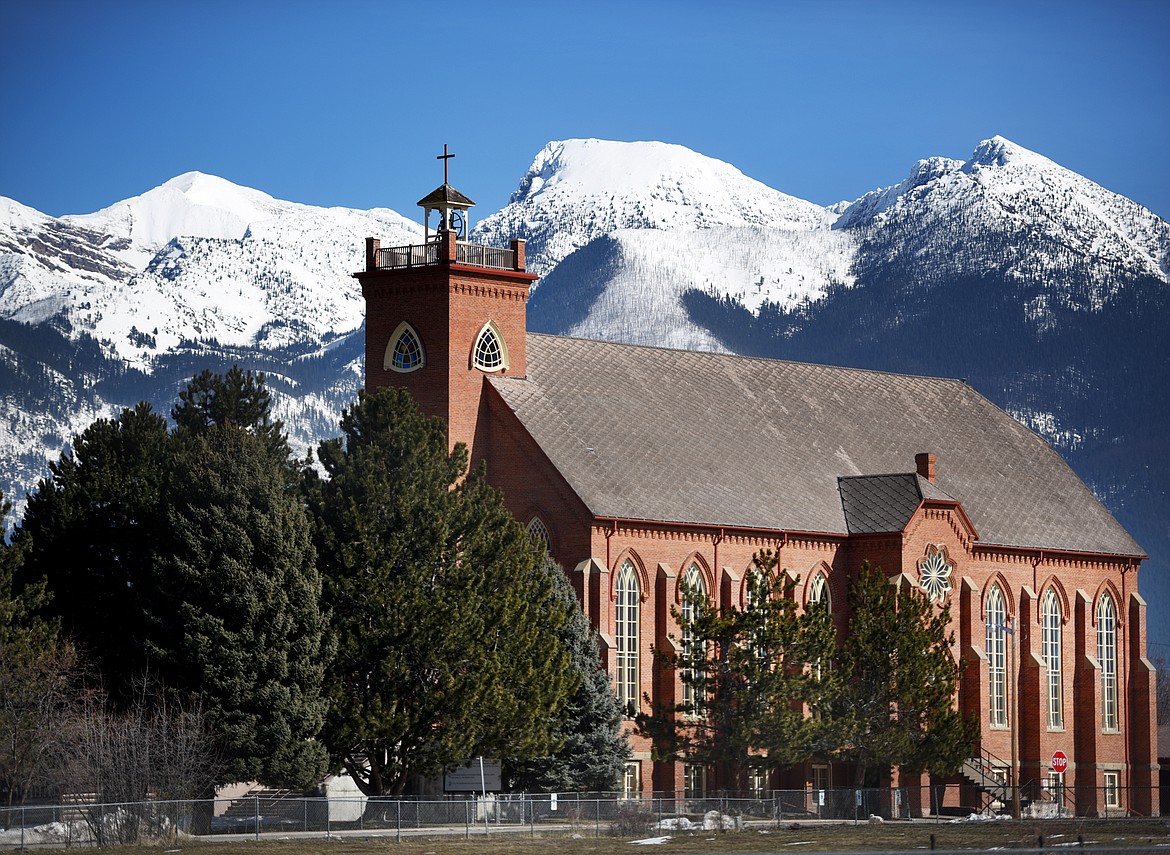 The historic Mission Catholic Church with the Mission Mountains  in the background.