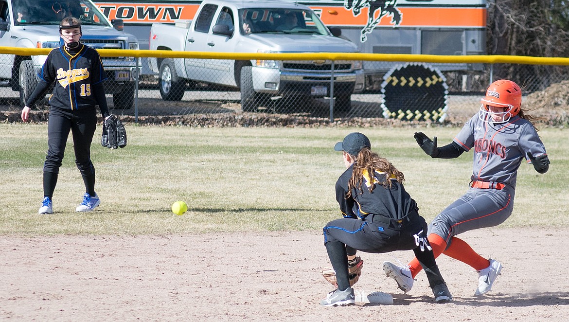Libby junior Jayden Winslow waits for a throw at second from sophomore Shayla Gallagher that came only moments late, with Broncs senior Morgan Snow called safe in the sixth inning of the Logger’s 3-2 loss to Frenchtown March 30. (Ben Kibbey/The Western News)