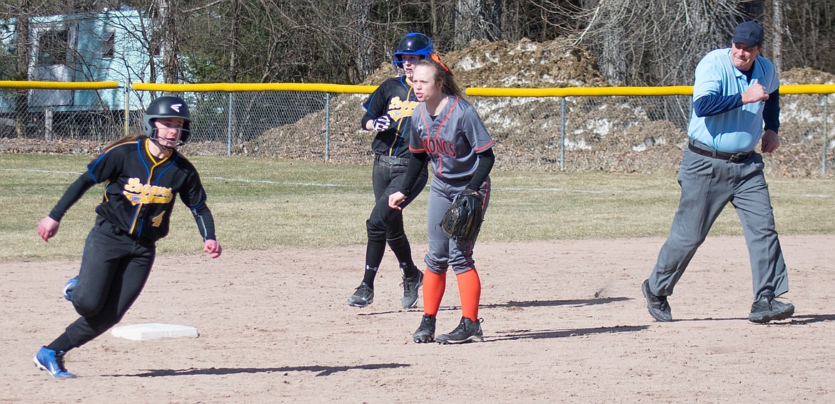 Libby junior Jayden Winslow follows close on the heels of freshman Bethany Thomas rounding second base after Thomas hesitated on a hit by Winslow during the fourth inning of the Lady Loggers&#146; 3-2 loss to Frenchtown, March 30. (Ben Kibbey/The Western News)