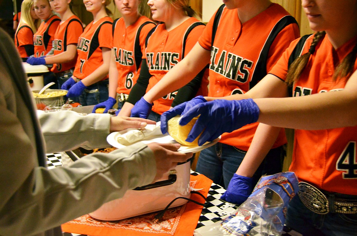 The Plains-Hot Springs High School softball team dishes out a barbecue-style dinner at the team fundraiser. (Erin Jusseaume photos/ Clark Fork Valley Press)