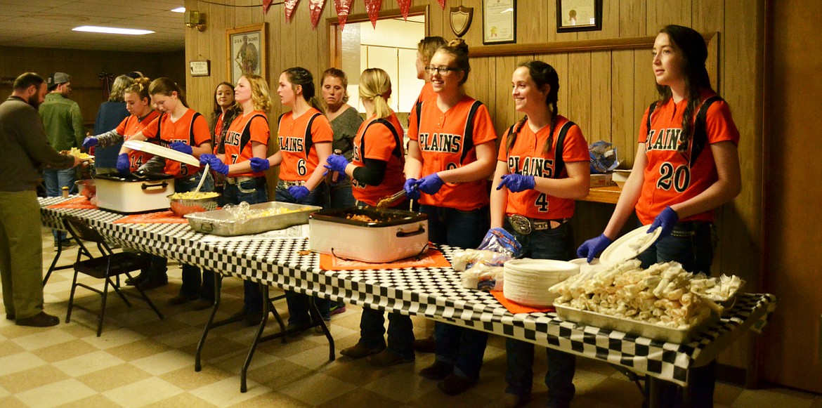 Team members dish up dinner for attendees. (Erin Jusseaume/Clark Fork Valley Press)