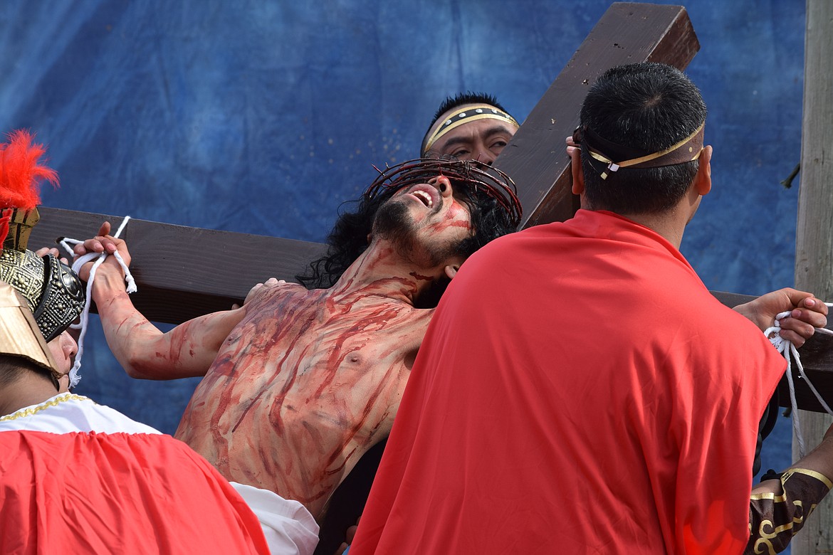 Charles H. Featherstone/Columbia Basin Herald
An actor portraying Jesus is lashed to his cross and ready to be crucified in Sacred Heart&#146;s Good Friday Passion Play in Othello.