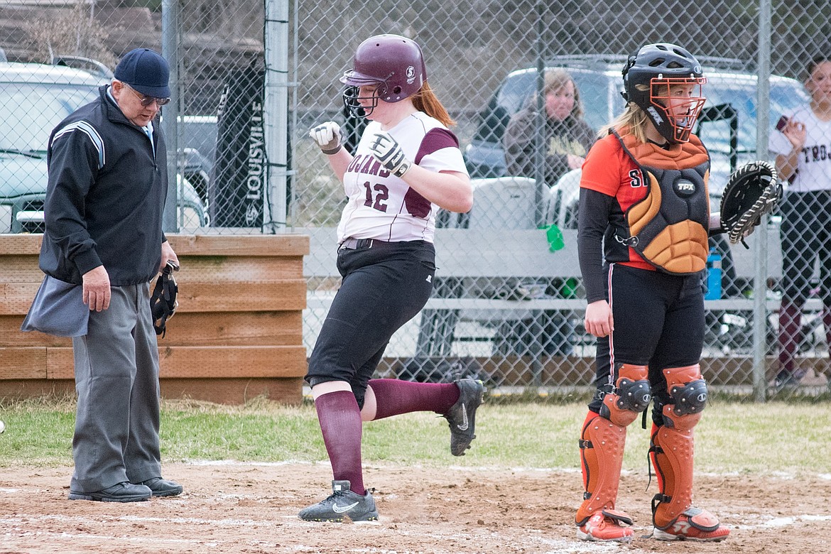 Troy junior Montana Rice clears home in the third inning, after junior Cami Finley hit a double that batted in Rice and junior Tristyn Winebark, scoring the team’s only points in their 19-2 loss to Priest River March 29. (Ben Kibbey/The Western News)