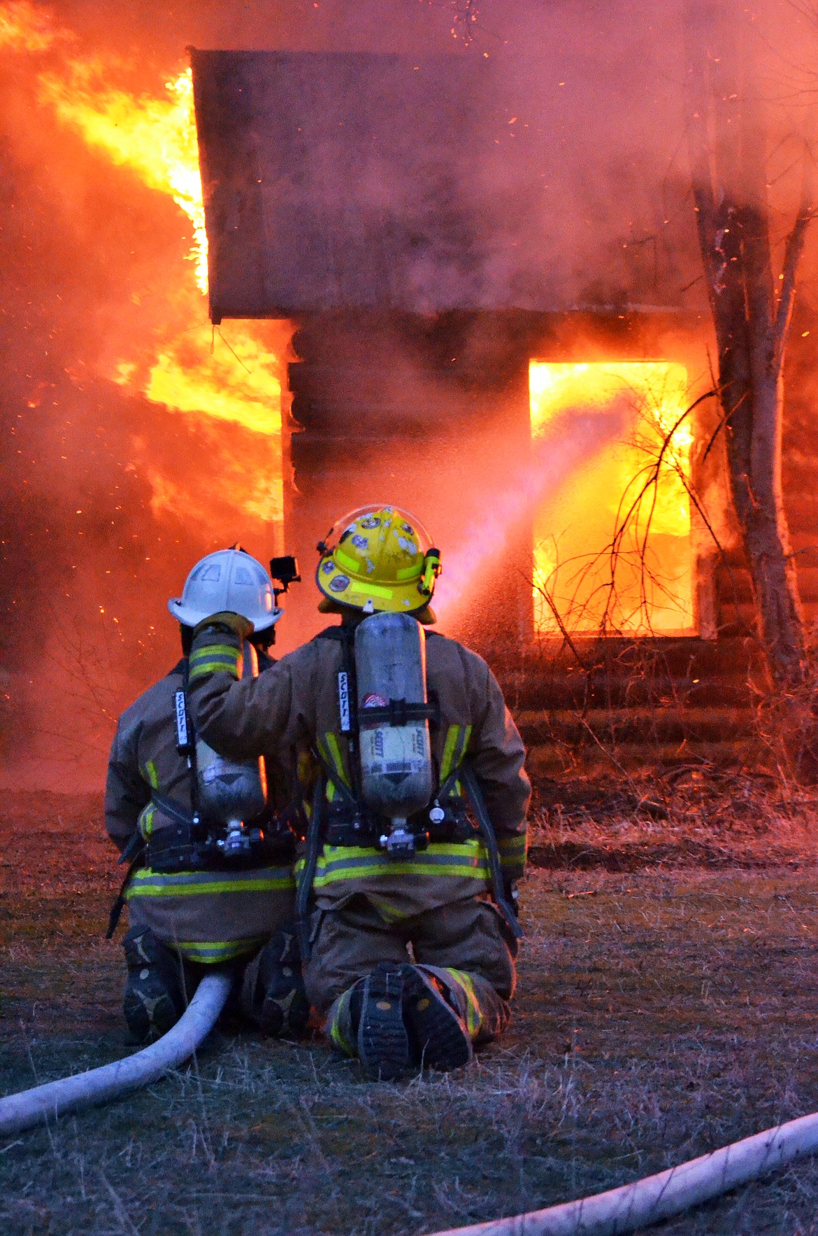 Fire fighters make sure a structure fire stays contained during a training session last week. (Erin Jusseaume/ Clark Fork Valley Press)