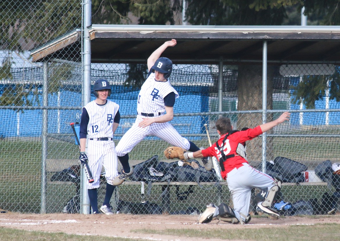 Photo by MANDI BATEMAN
Badger baserunner Mason Eby avoids the tag of Sandpoint&#146;s Hunter Donahoe to score a run during a March 29 doubleheader in Bonners Ferry. The Bulldogs won both games, 3-1 and 14-3.