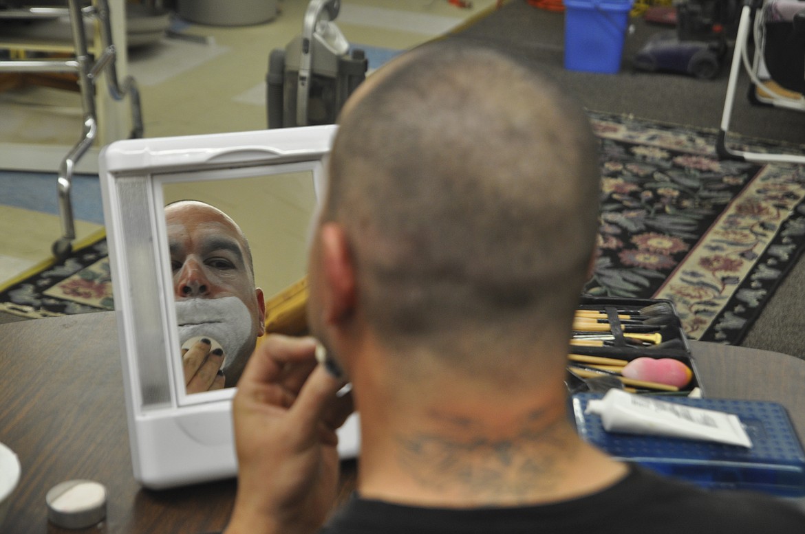 IT TAKES about an hour for Ronan resident Travis Bynum to apply his clown makeup. Bynum has taught himself how to do his own makeup for what he and his children call a &#147;free-range clown&#148; act. (Ashley Fox/Lake County Leader)