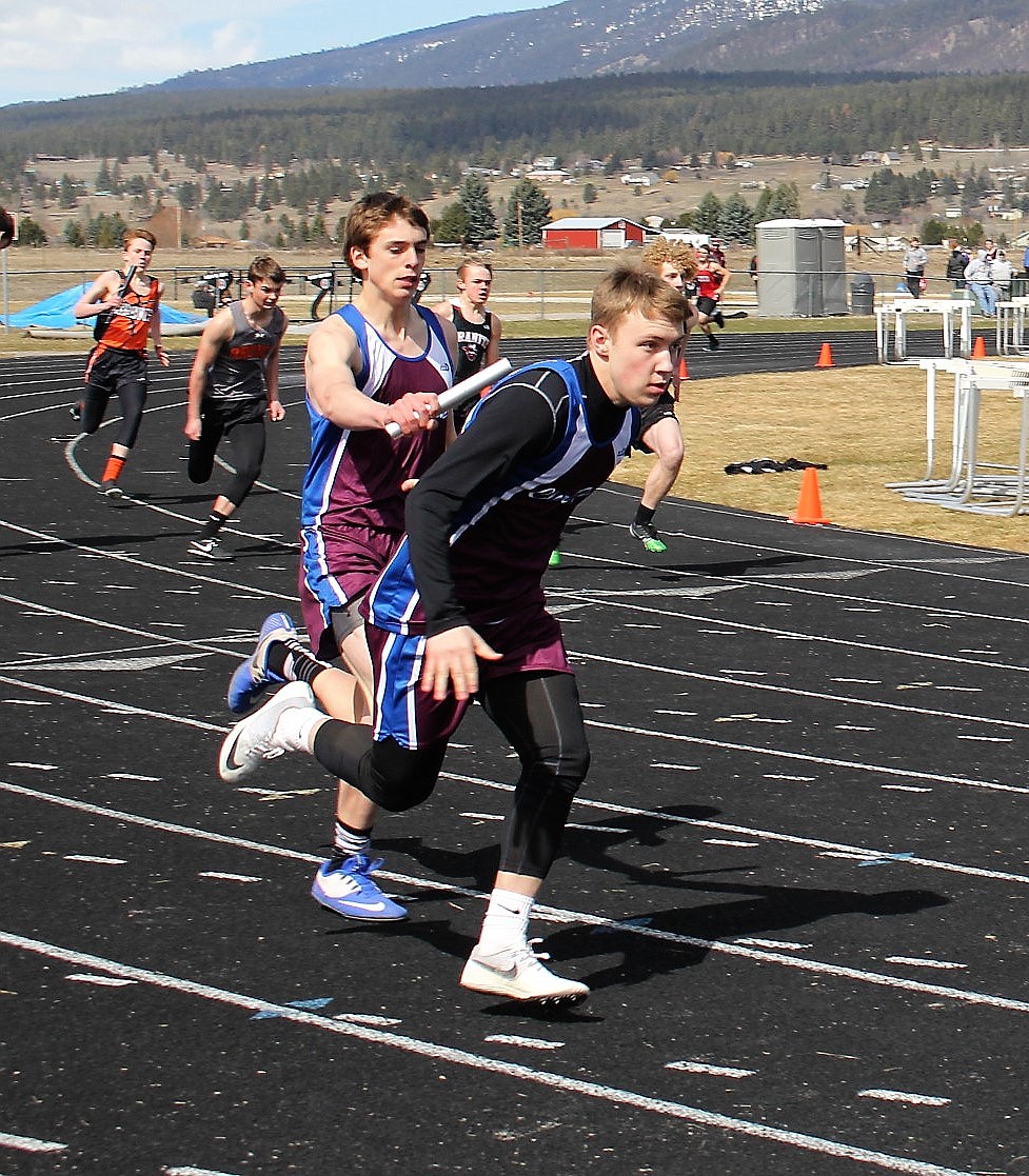 CLARK FORK'S Carson Callison hands off the baton to Bryan Mask in the boys relay during the Jim Johnson Track Meet on Thursday. See story and results on Page A4. (Kathleen Woodford/Mineral Independent)