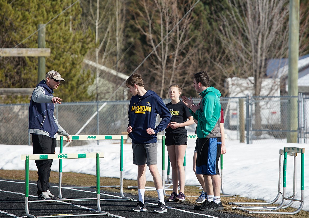 Whitefish Track and Field coach Scott Smith works with hurdlers during a spring break practice last week.