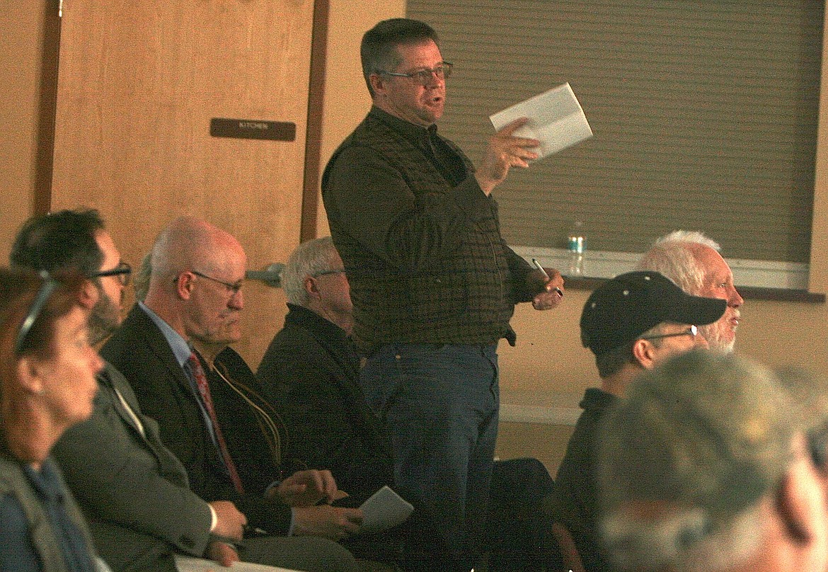 Rathdrum resident Tim Kastning directs questions about the proposed Avista Utilities-Hydro One Limited merger at Idaho Public Utilities Commission staff on Wednesday night at the Midtown Meeting Center in Coeur d'Alene. (BRIAN WALKER/Press)