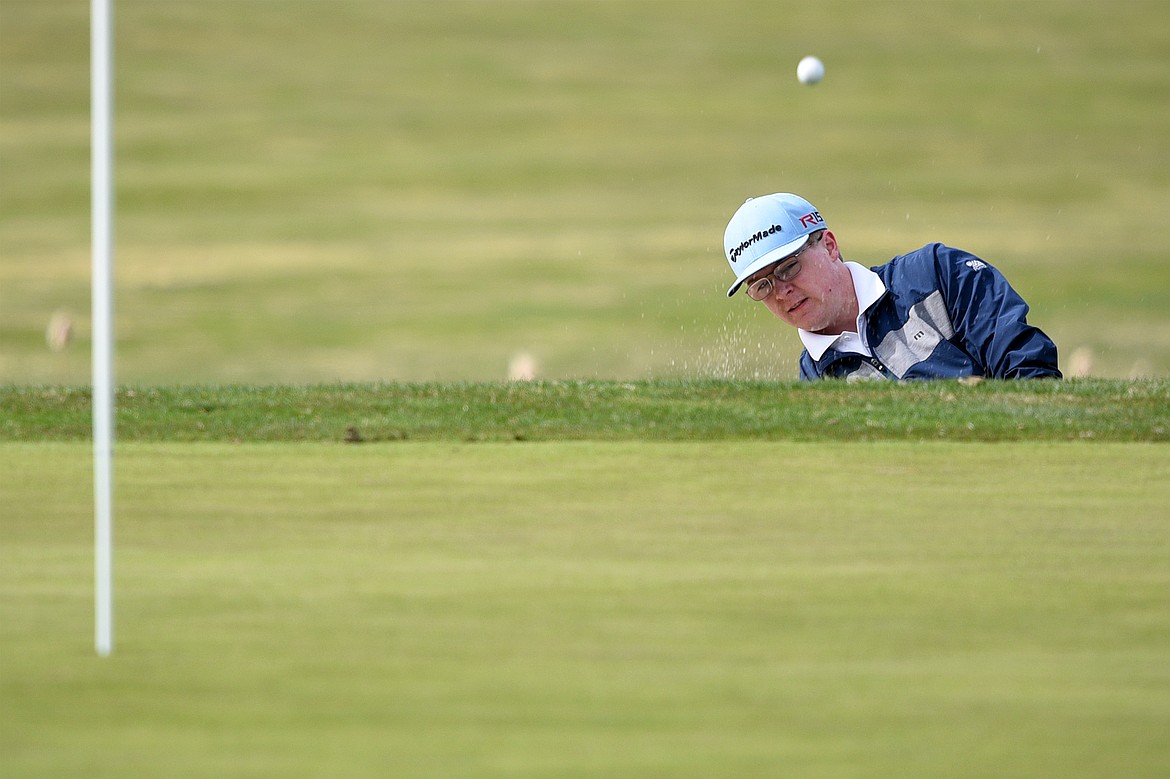 Bigfork&#146;s Augie Emslie chips from a greenside bunker on hole No. 2 at Eagle Bend Golf Club in Bigfork on Thursday. (Casey Kreider/Daily Inter Lake)