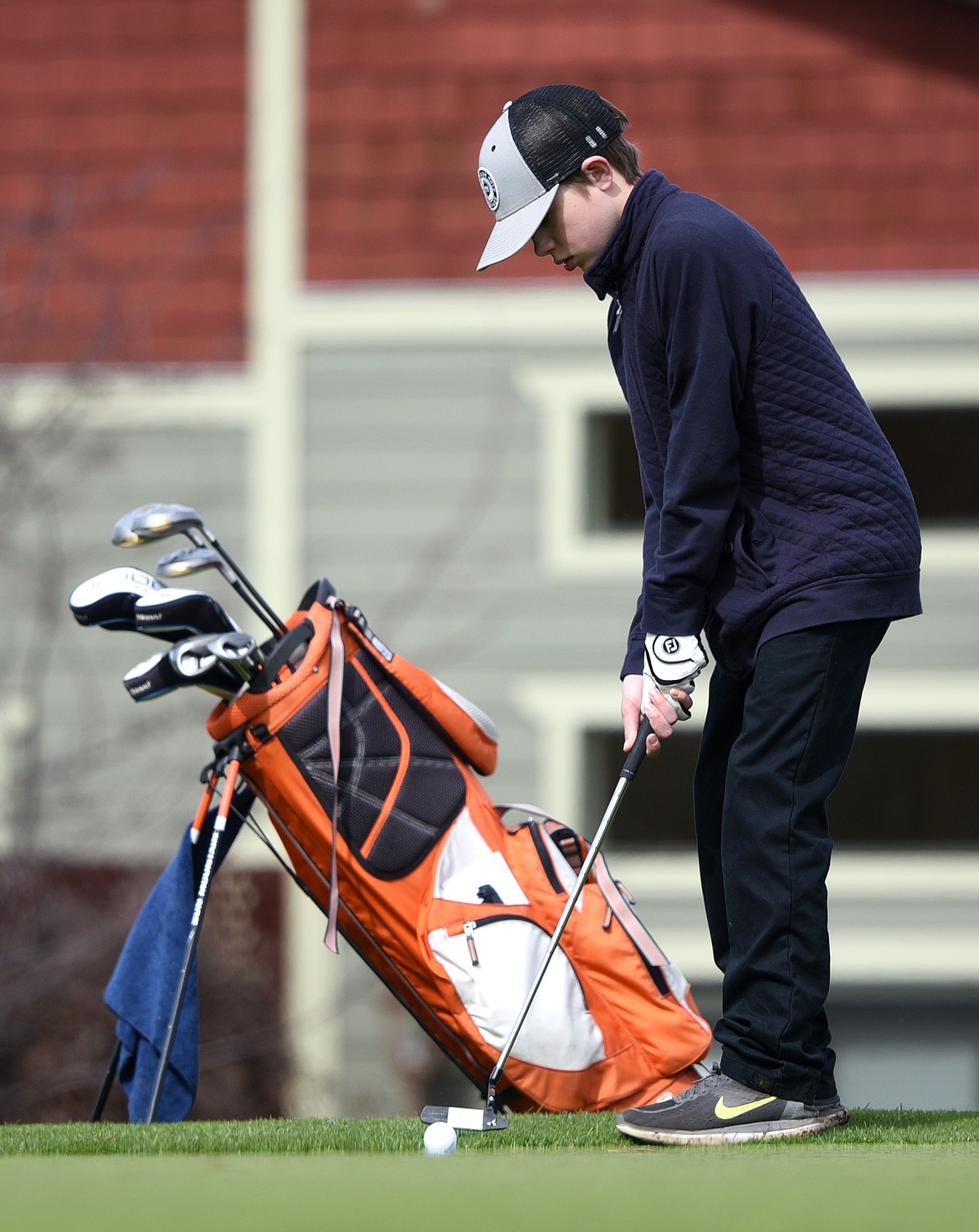 Eureka&#146;s Kaden Benford putts on the 14th green at Eagle Bend Golf Club in Bigfork on Thursday. (Casey Kreider/Daily Inter Lake)