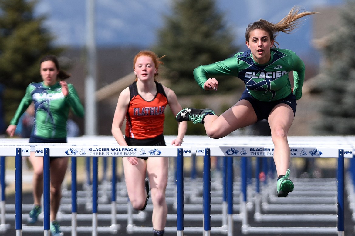 Glacier High School&#146;s Faith Brennan completes the 100-meter hurdles in a time of 16.64 in a meet with Flathead High School at Glacier High School on Tuesday. (Casey Kreider/Daily Inter Lake)