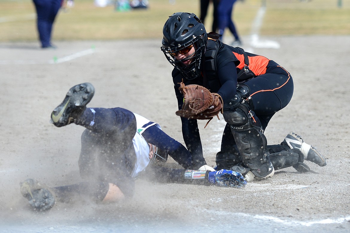 Glacier's Sophie Smith is tagged out at the plate by Flathead catcher Jayden Russell in the bottom of the 4th inning on Tuesday. (Casey Kreider/Daily Inter Lake)