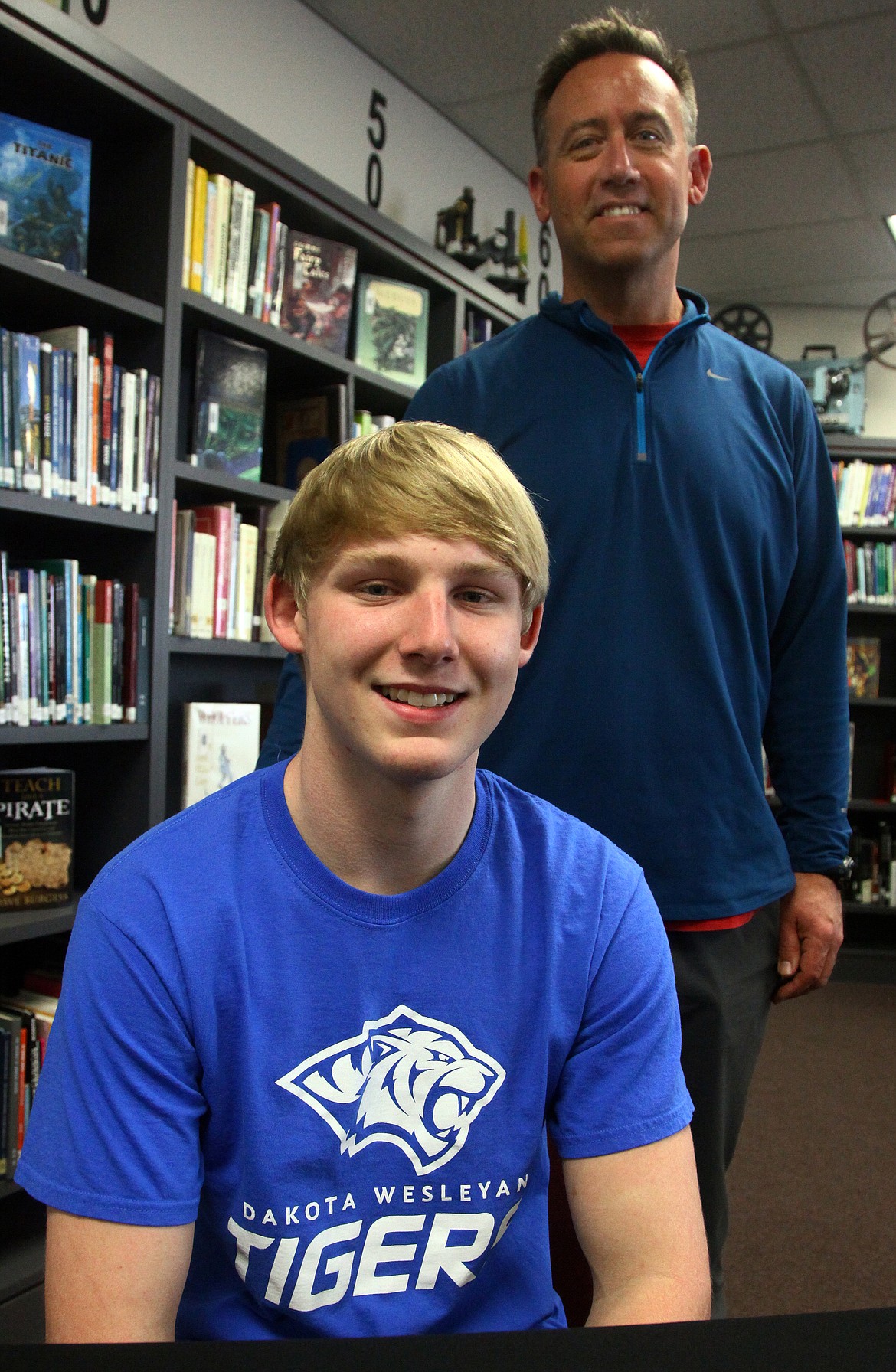 Rodney Harwood/Columbia Basin HeraldEphrata senior Jakob Oxos, pictured with Tiger coach Jay Mills, will continue his football career at Dakota Wesleyan University.