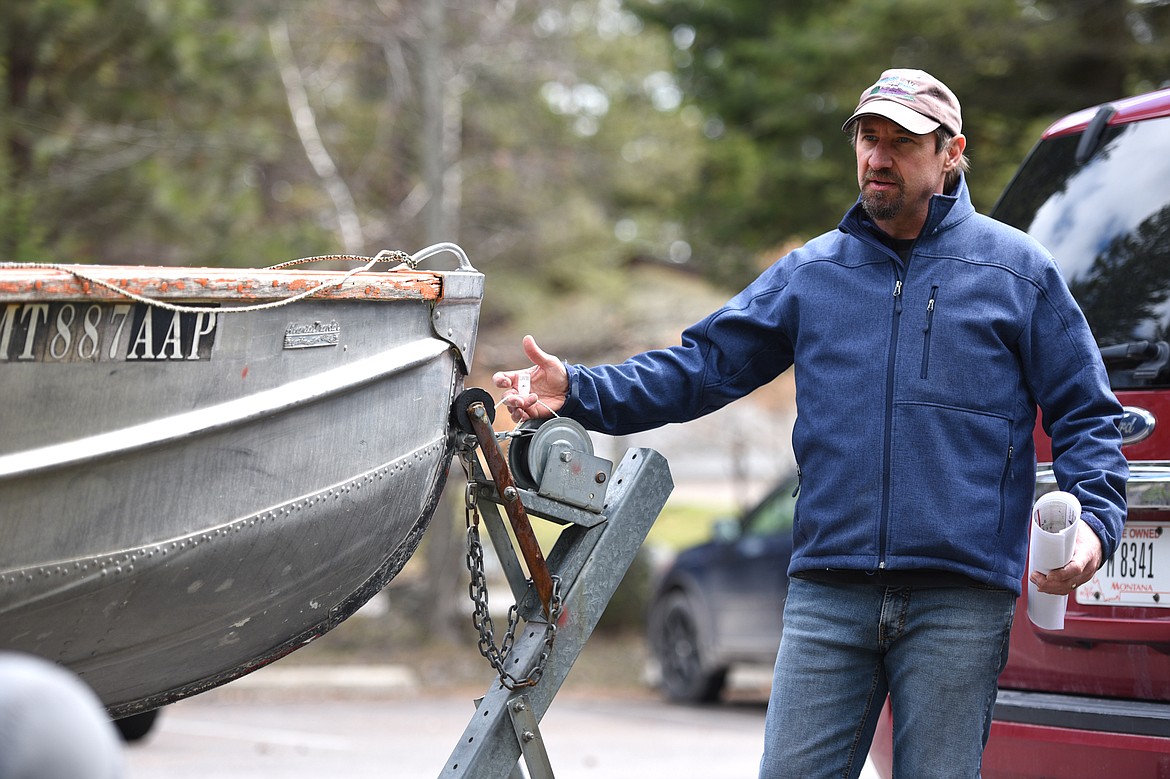 Phil Matson, a research specialist with Flathead Lake Biological Station, shows a tag from a watercraft inspection station during the Flathead Lake Community Mussel Walk at the Wayfarers Unit of Flathead Lake State Park in Bigfork on Saturday. (Casey Kreider/Daily Inter Lake)