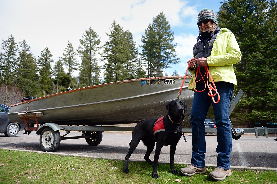 Deb Tirmenstein, of Montana Black Dog Services, and one of her dogs, Ismay, at the Flathead Lake Community Mussel Walk at the Wayfarers Unit of Flathead Lake State Park in Bigfork on Saturday. Tirmenstein has trained her dogs to search for mussels. (Casey Kreider/Daily Inter Lake)