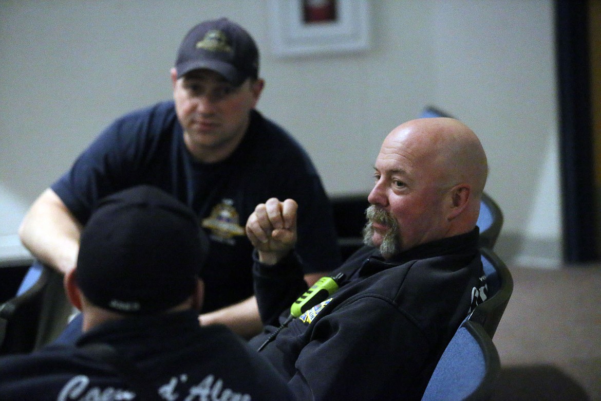 Blaine Porter looked on as fellow Coeur d&#146;Alene Fire Department firefighters Steve Jones and Ben Hector practiced the QPR method of suicide prevention Thursday night. (JUDD WILSON/Press)