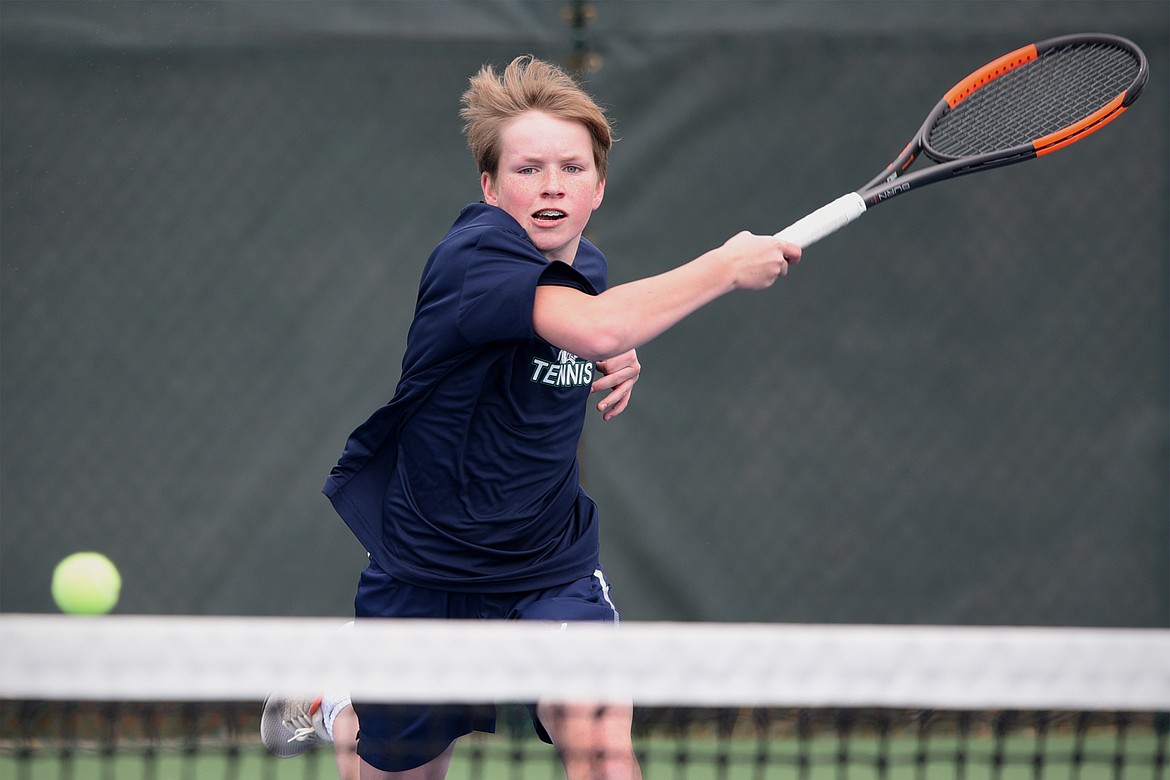 Glacier's Rory Smith hits a return against Flathead's Ethan Hawkins at Flathead Valley Community College on Friday. (Casey Kreider/Daily Inter Lake)