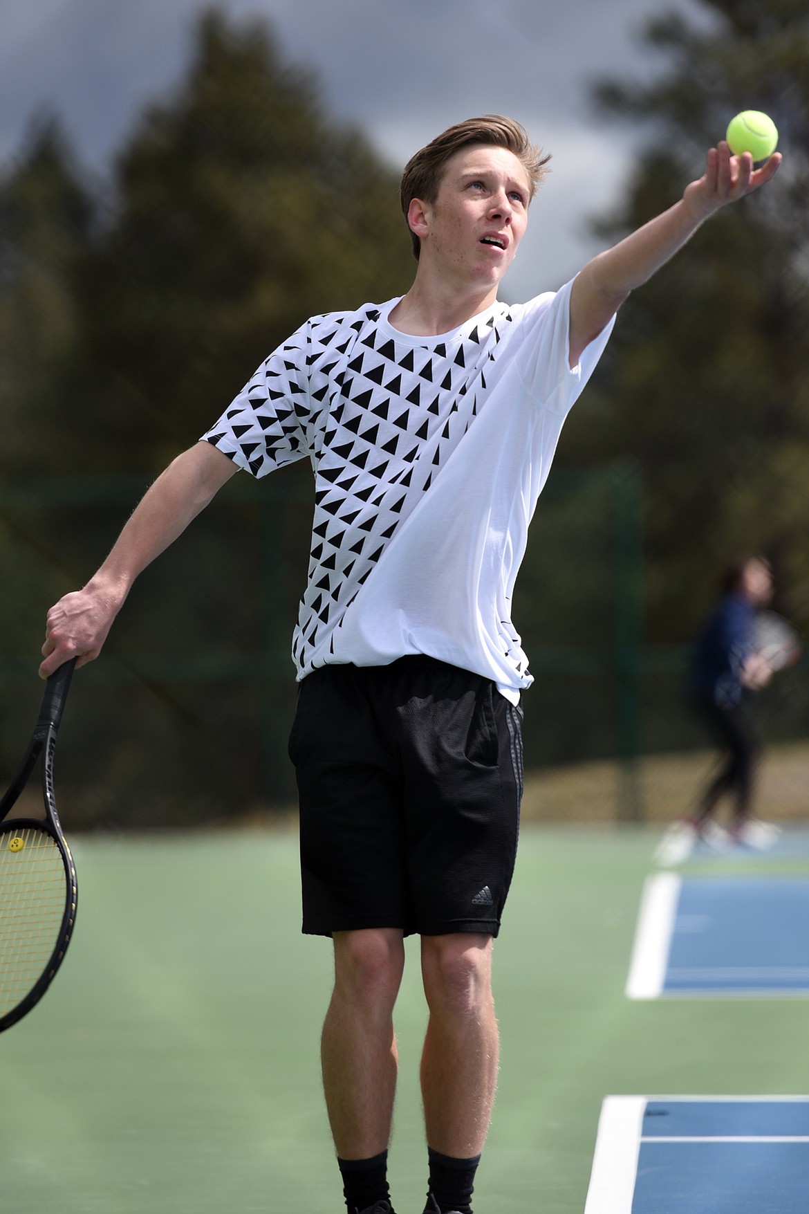 Flathead's Ethan Hawkins serves against Glacier's Rory Smith at Flathead Valley Community College on Friday. (Casey Kreider/Daily Inter Lake)