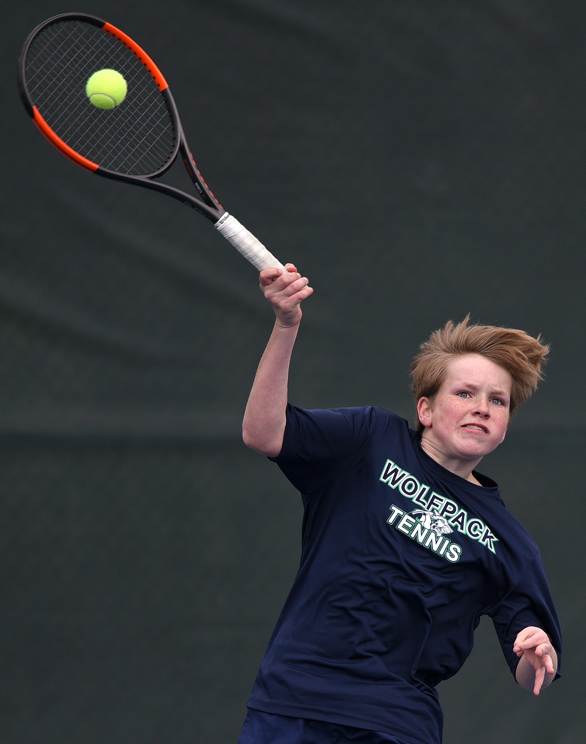 Glacier's Rory Smith hits a return against Flathead's Ethan Hawkins at Flathead Valley Community College on Friday. (Casey Kreider/Daily Inter Lake)