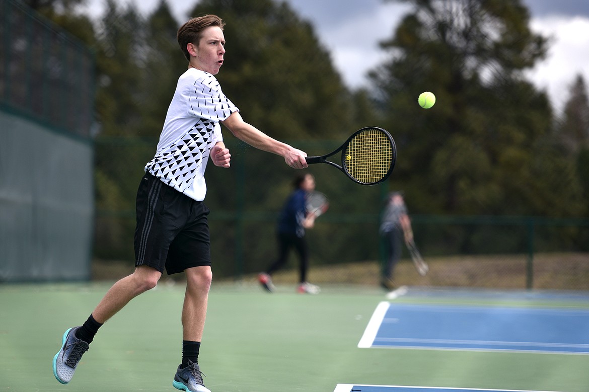 Flathead's Ethan Hawkins hits a return against Glacier's Rory Smith at Flathead Valley Community College on Friday. (Casey Kreider/Daily Inter Lake)