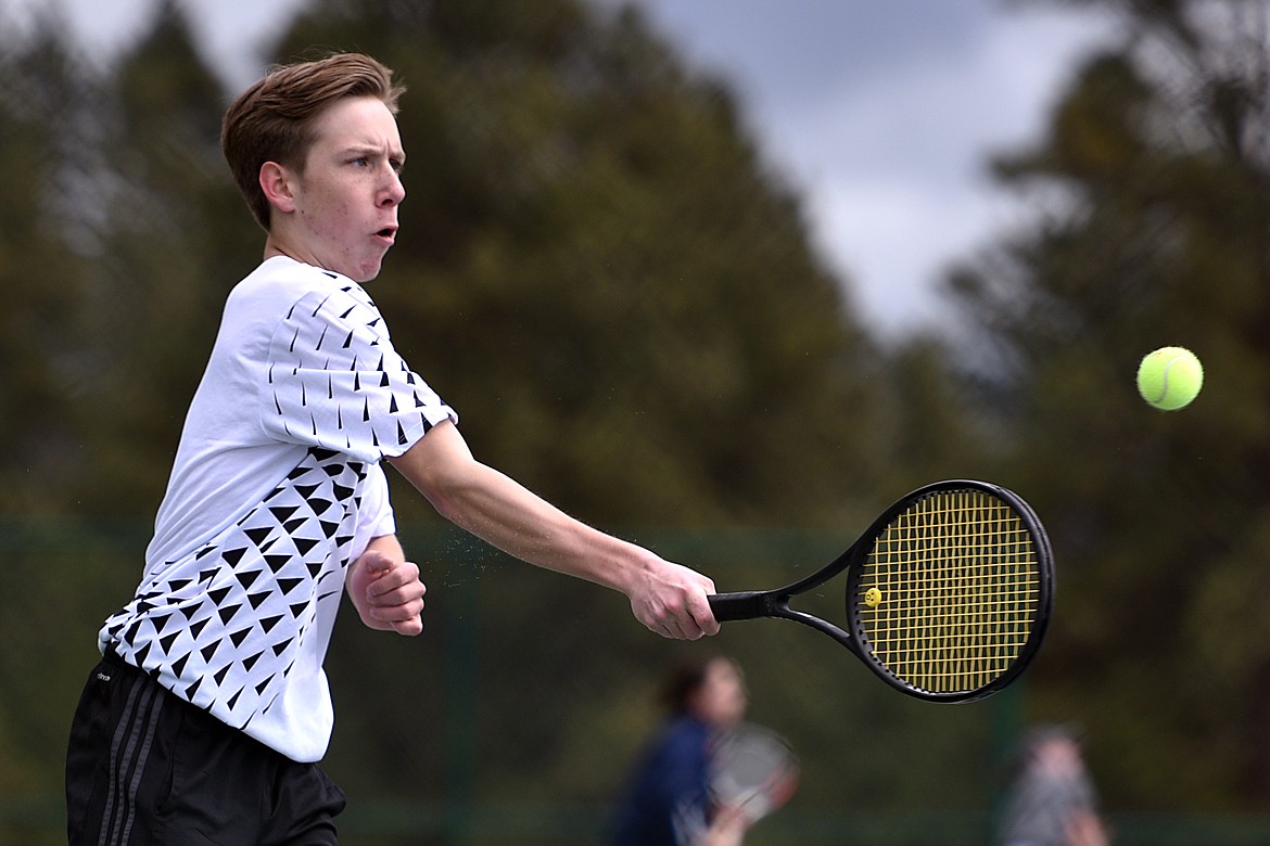 Flathead's Ethan Hawkins hits a return against Glacier's Rory Smith at Flathead Valley Community College on Friday. (Casey Kreider/Daily Inter Lake)