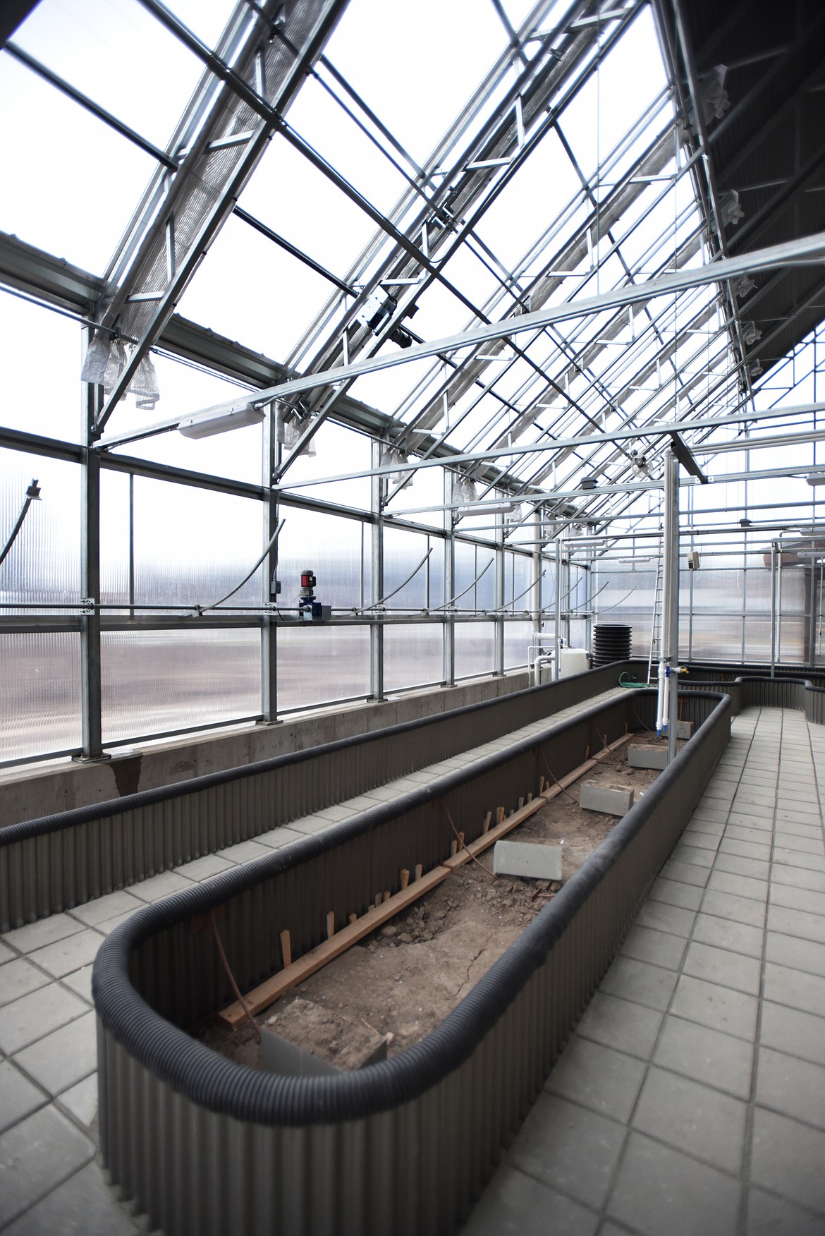 Interior of the greenhouse at the&#160;Center for Sustainability and&#160;Entrepreneurship at Whitefish High School. The greenhouse is heated in three ways. The primary is the climate battery which draws heat during the day, stores it underground and releases it during the night. Stage two is an air source heat pump which is 100 percent effective and under the right circumstances can be up to 340 percent effective. And the final stage is two gas-fired heating units.&#160;Morrison-Maierle of Kalispell designed the mechanical and electrical infrastructure and Montana Creative of Whitefish is responsible for the architecture.
(Brenda Ahearn/Daily Inter Lake)