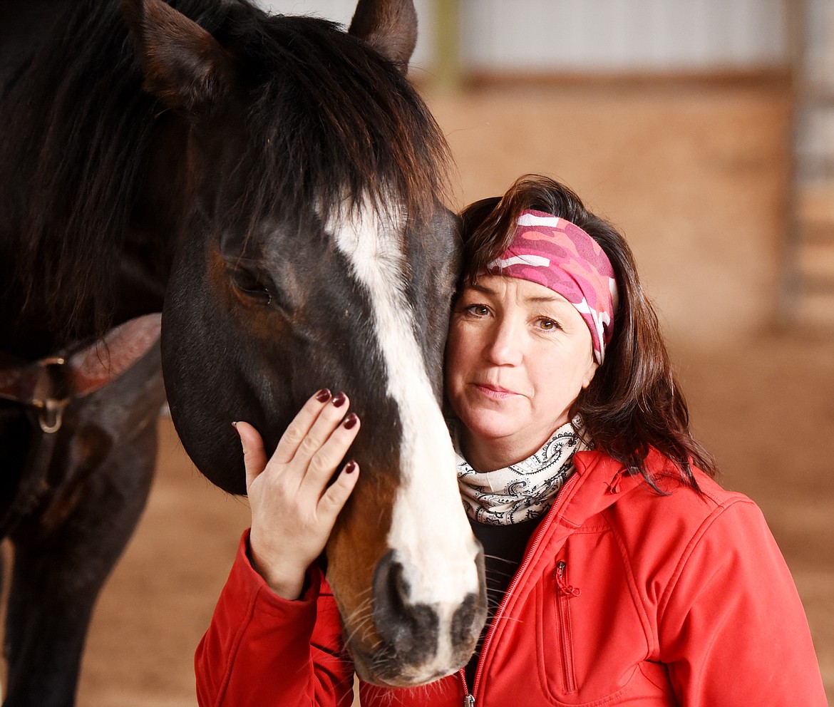 Stacia Stevens, owner of Gentle Persuasion Horse Training with Jess, one of the stallions she trained on Friday, April 6, out in Smith Valley.&#160;Stevens will host an open house at her home for those interested in the Extreme Cowboy&#160;Association April 15 at 2:30 p.m. at 304 Batavia Lane, Kalispell.(Brenda Ahearn/Daily Inter Lake)