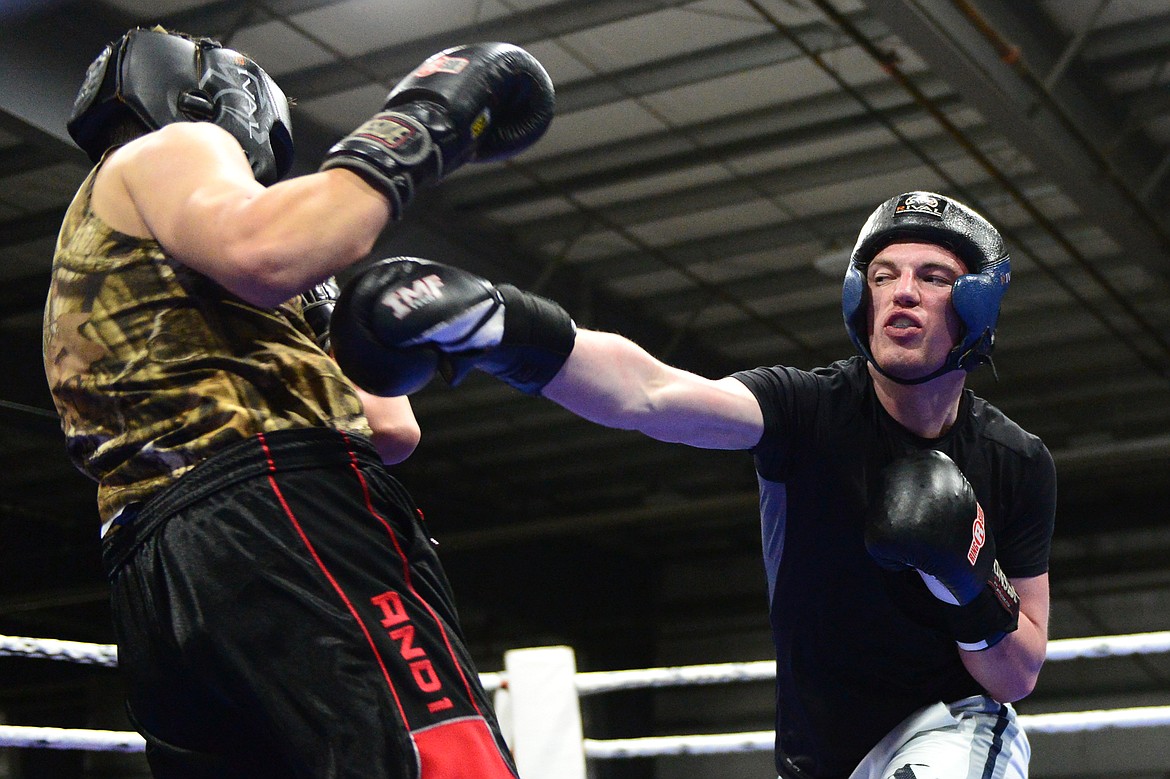 Glacier's Robert Hurly exchanges punches with Flathead's John Jones at the 9th annual Crosstown Boxing Smoker at the Flathead County Fairgrounds on Thursday night. Hurly won the bout. (Casey Kreider/Daily Inter Lake)