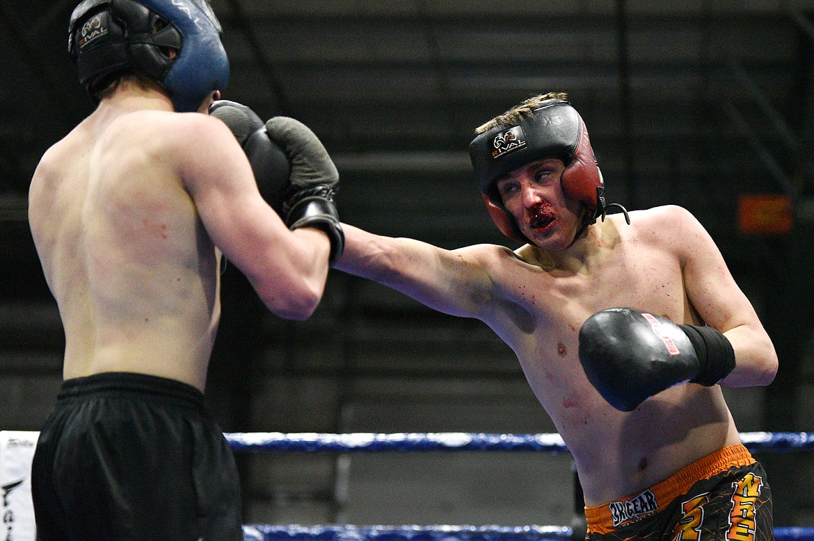 Flathead High School's Dallas Moore, right, exchanges punches with Columbia Falls' Brandon Thomas at the 9th annual Crosstown Boxing Smoker at the Flathead County Fairgrounds on Thursday night. Moore won the bout. (Casey Kreider/Daily Inter Lake)