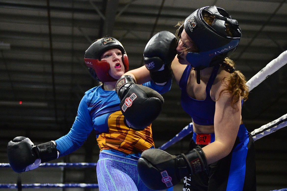 Flathead High School's Shelby Daniels, left, exchanges punches with Bigfork High School's Elyse Pendlay at the 9th annual Crosstown Boxing Smoker at the Flathead County Fairgrounds on Thursday night. Daniels won the bout. (Casey Kreider/Daily Inter Lake)