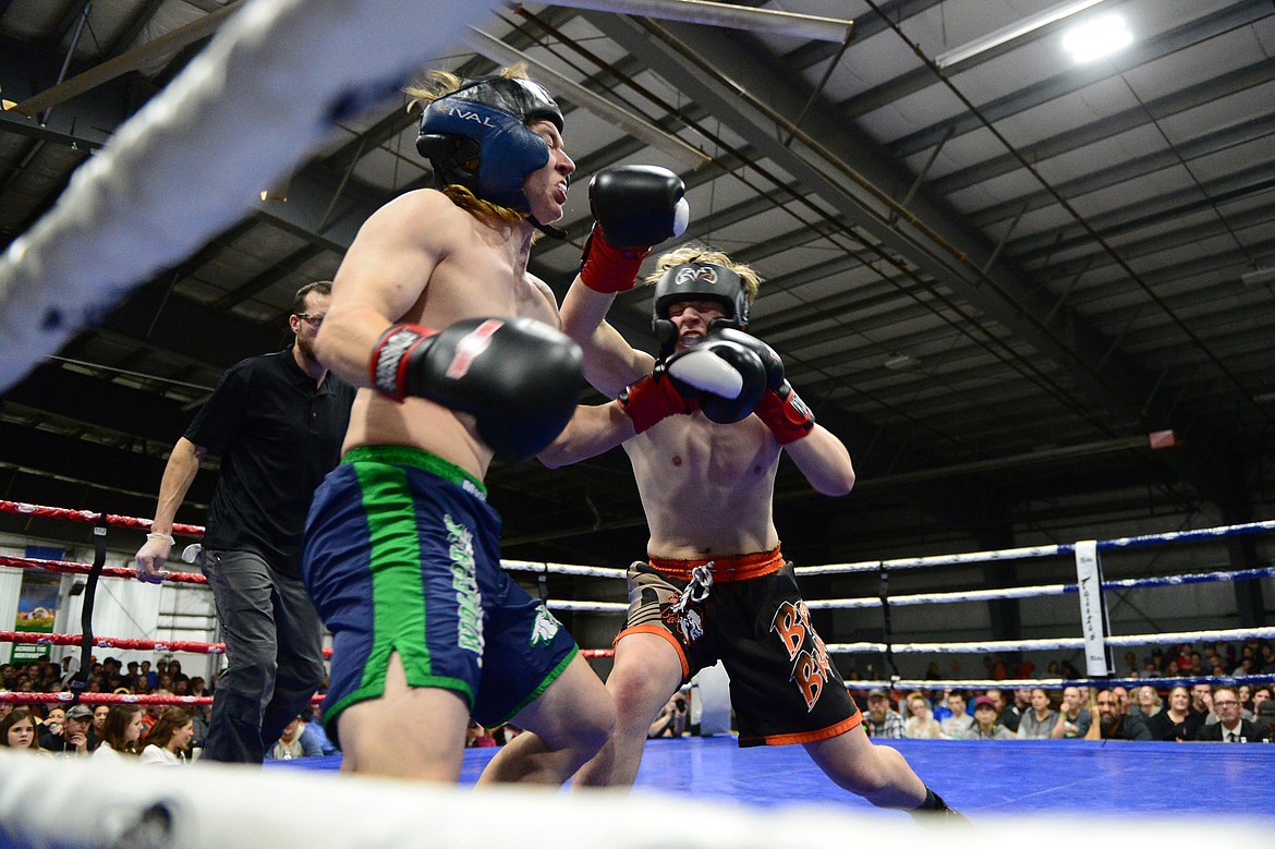 Glacier's Brandon Jordan, left, and Flathead's Jonathon Hamilton square off at the 9th annual Crosstown Boxing Smoker at the Flathead County Fairgrounds on Thursday night. Hamilton won the bout. (Casey Kreider/Daily Inter Lake)