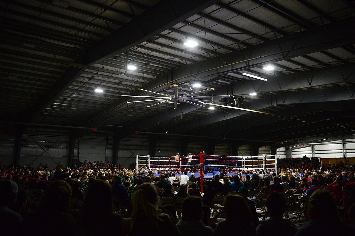 Whitefish High School's Trey Baumgartner-Siers boxes Glacier High School's Adam Bartlett at the 9th annual Crosstown Boxing Smoker at the Flathead County Fairgrounds on Thursday night. (Casey Kreider/Daily Inter Lake)