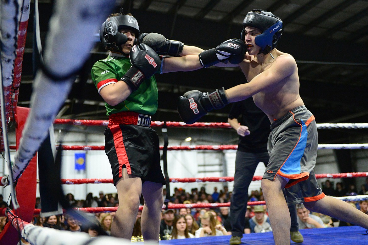 Glacier's Justin Gronley, right, and Columbia Falls' Kevin Maldonado square off at the 9th annual Crosstown Boxing Smoker at the Flathead County Fairgrounds on Thursday night. Gronley won the bout. (Casey Kreider/Daily Inter Lake)