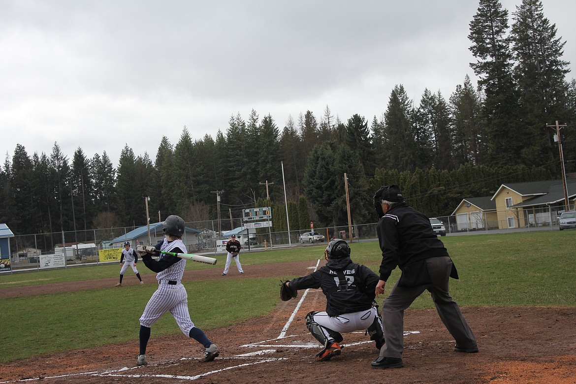 Mason Eby hits the ball into the air as Chris Sabin takes his lead at first base.