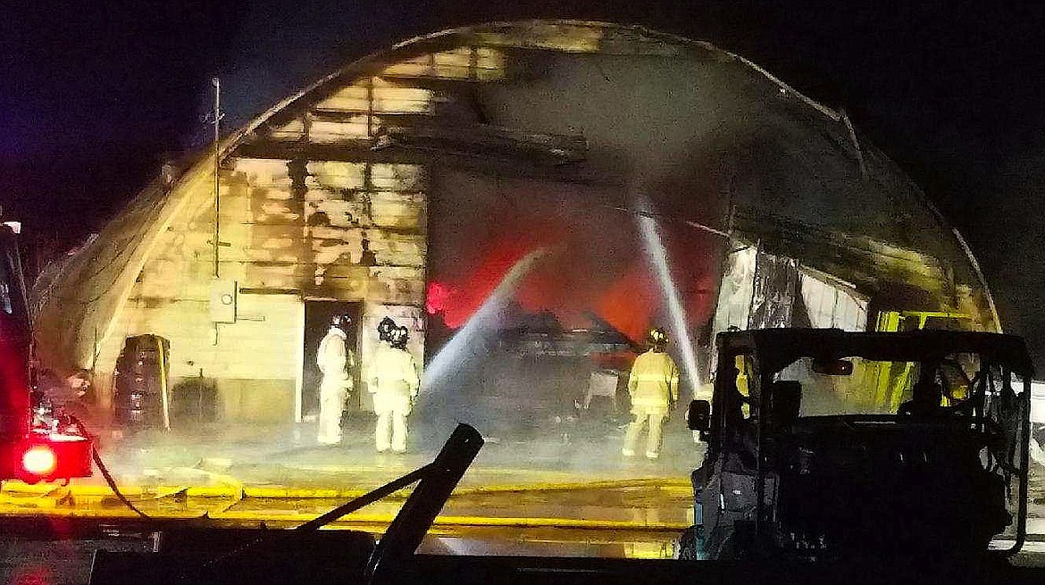Firefighters tend to a storage building fire on Prairie Avenue north of Post Falls on Tuesday night and Wednesday morning. The building and all of the contents inside were a total loss. (Courtesy of Kootenai County Fire and Rescue)