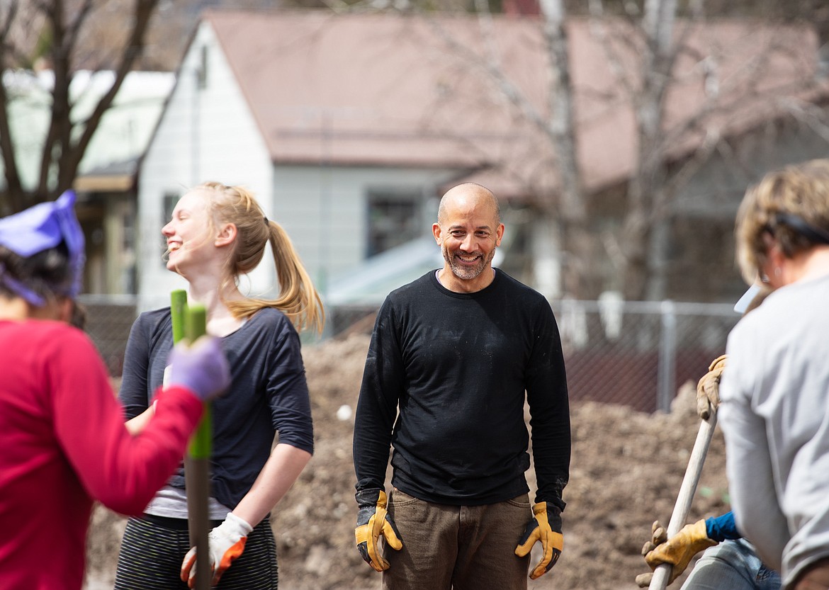 Shawn Watts smiles as he and other community members work with students on the Community Day of Action at the Center for Sustainability and Entrepreneurship on Saturday.p