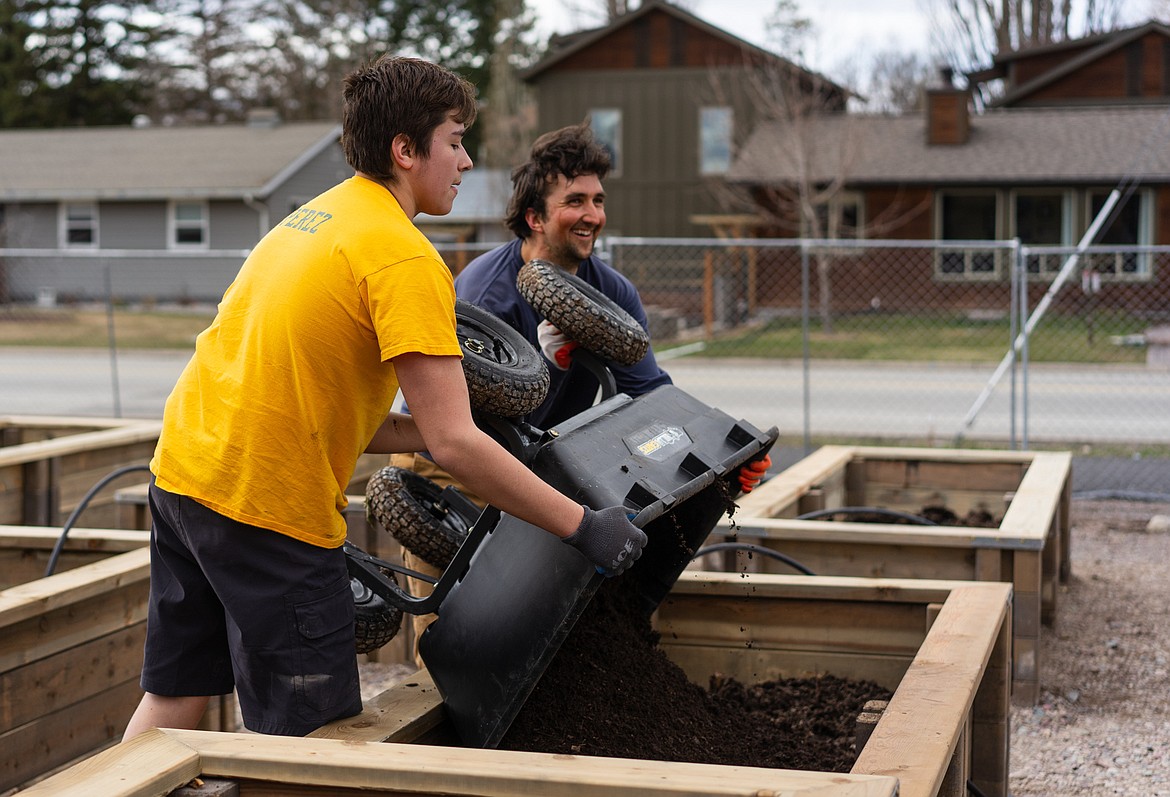 Student Matthew Perez and district curriculum director Ryder Delaloye fill planters at the Center for Sustainability and Entrepreneurship on Saturday.