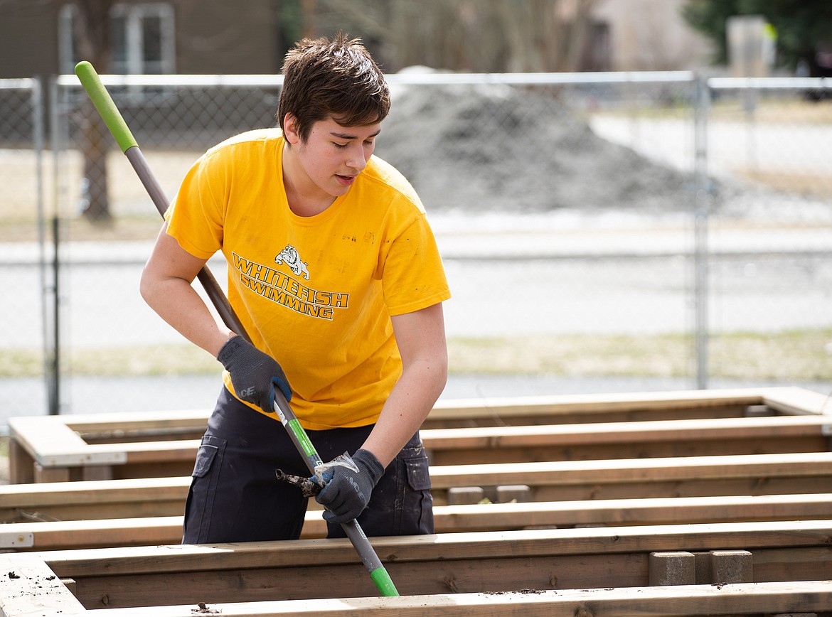 Whitefish High School student Matthew Perez tends to a planter at the Center for Sustainability and Entrepreneurship on Saturday.